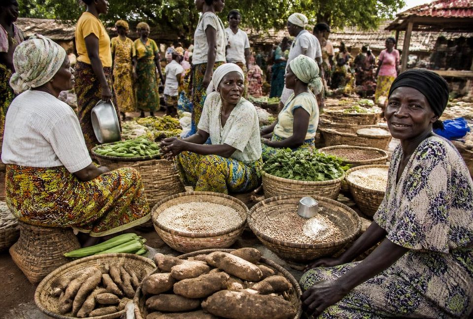 Women selling grain, yams and vegetables at a rural open-air market